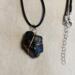 Lump of black obsidian, tied with copper, crosses in the front